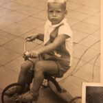 Robert Enzerink on a tricycle at about age 4